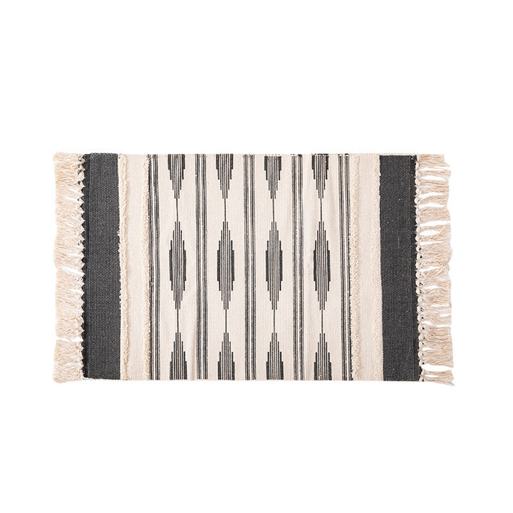 Flat Boho runner rug made of cotton blend fabric with geometric hexagon tufting and decorative fringed edge.