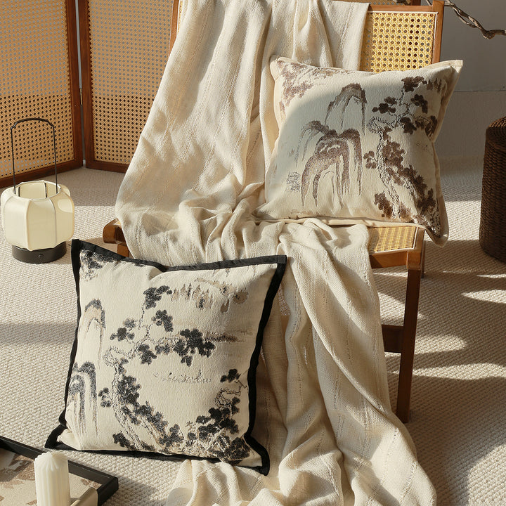 Elegant decorative pillow with intricate landscape illustration