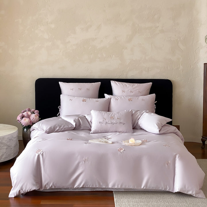 Cotton satin bedding set with delicate bow and flower embroidery as well as pillowcases