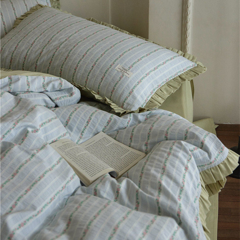 Bedding set with fine striped texture, ruffled border and breathable cotton blend