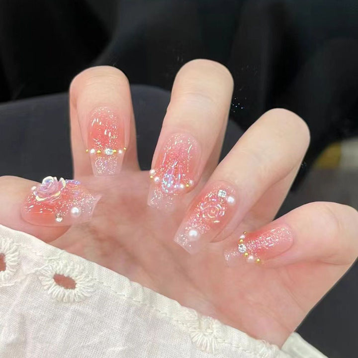 Artistic Nail Art with Glitter and Flower Applications Stornfield