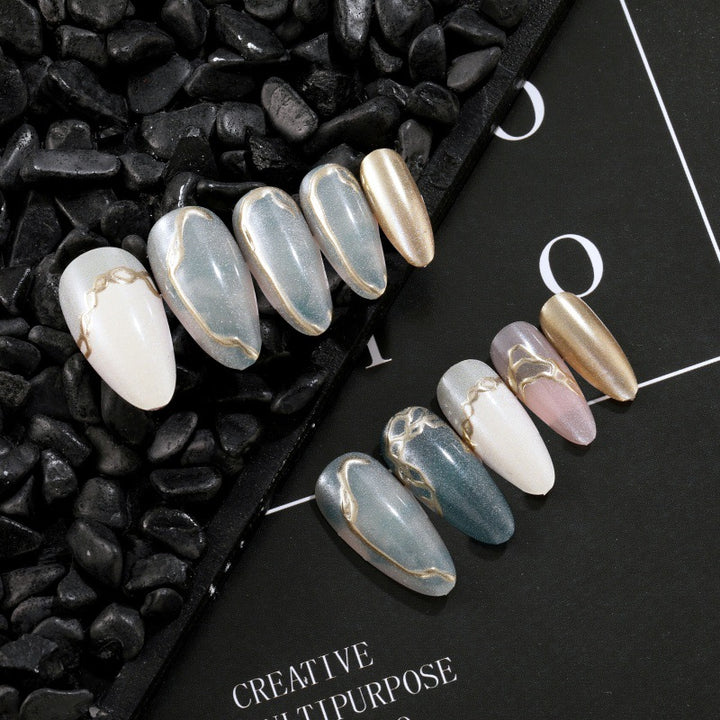 Artificial nails with elegant golden accents Stornfield