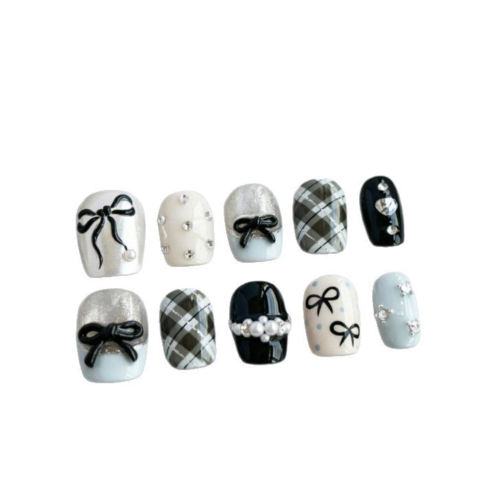 Artificial nails with elegant bows and rhinestones Stornfield