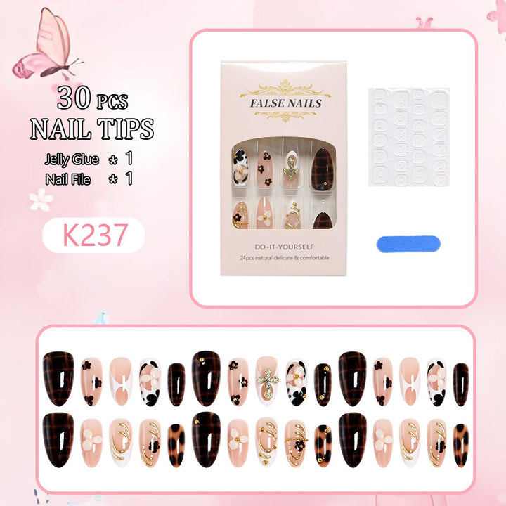 Artificial nails set with elegant gold accents and floral embellishments Stornfield