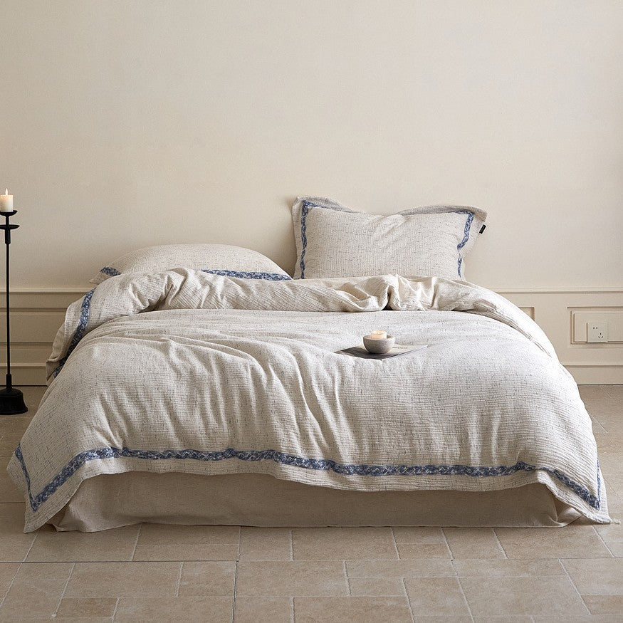 Linen bedding set with woven texture and subtle indigo border