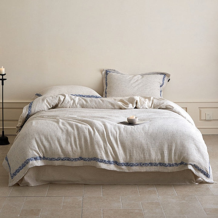 Linen bedding set with woven texture and subtle indigo border