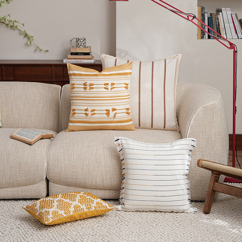 Structured square decorative pillow with crocheted trim and striped knit texture