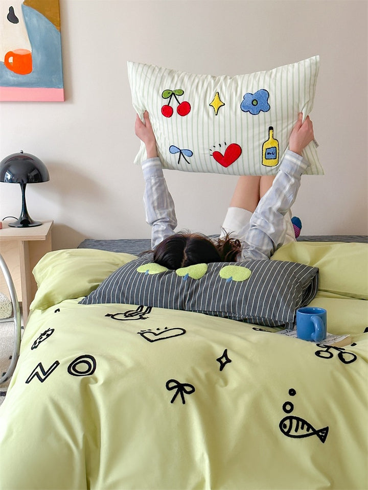 Playful cotton duvet cover set with embroidered motifs and soft fitted sheet