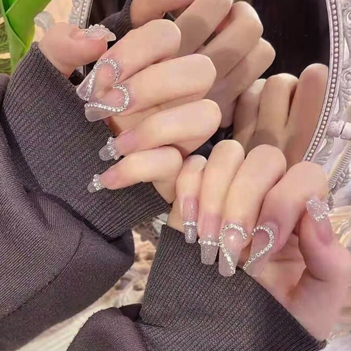 Glamorous artificial nails with heart and glitter design Stornfield