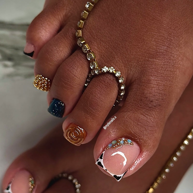 Acrylic nail set with luxurious golden embellishments Stornfield