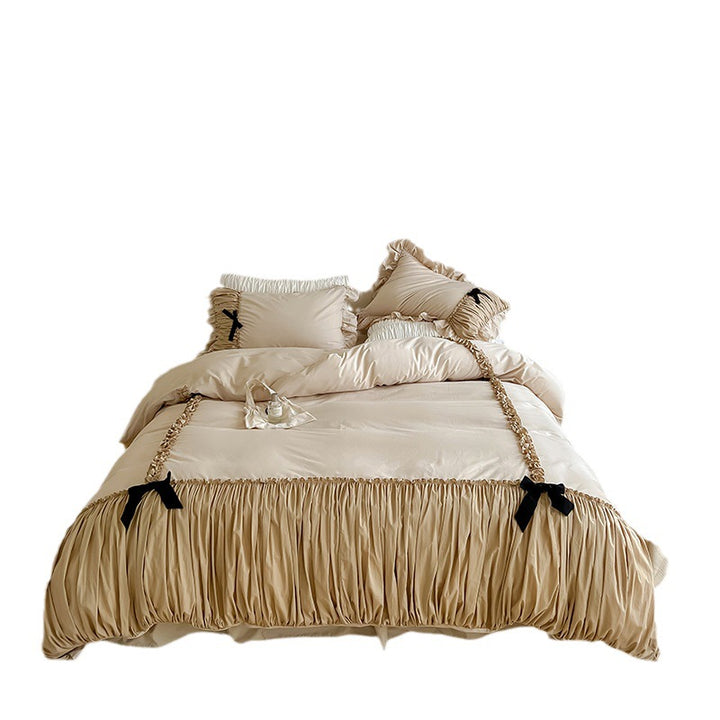 Luxurious satin bedding set with gathered ruffle, braided decorative ribbons and bow appliqué