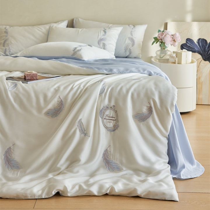 Reversible cotton satin bedding set with finely embroidered feather motifs and a silky-matte finish
