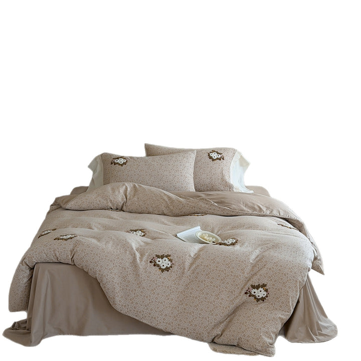 Embroidered bed set made of fine cotton satin with gathered bed skirt and decorative pillows