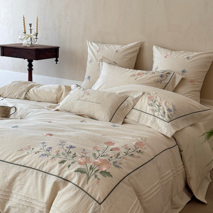 Natural fiber duvet cover set with delicate floral hand embroidery, linen look, and decorative ruffle