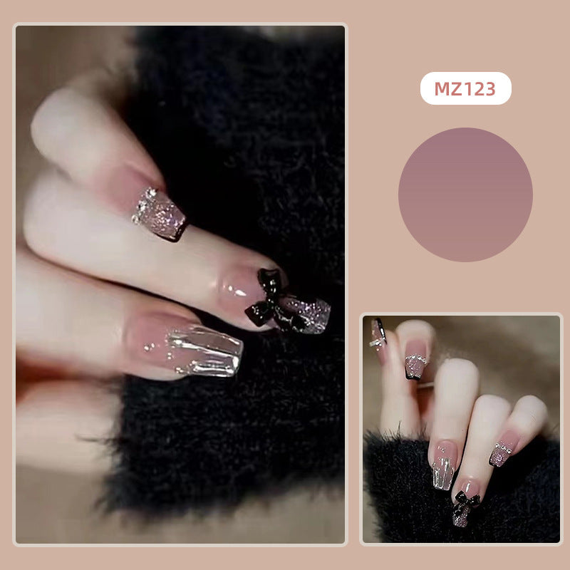 Elegant nail design with bow and rhinestone details Stornfield