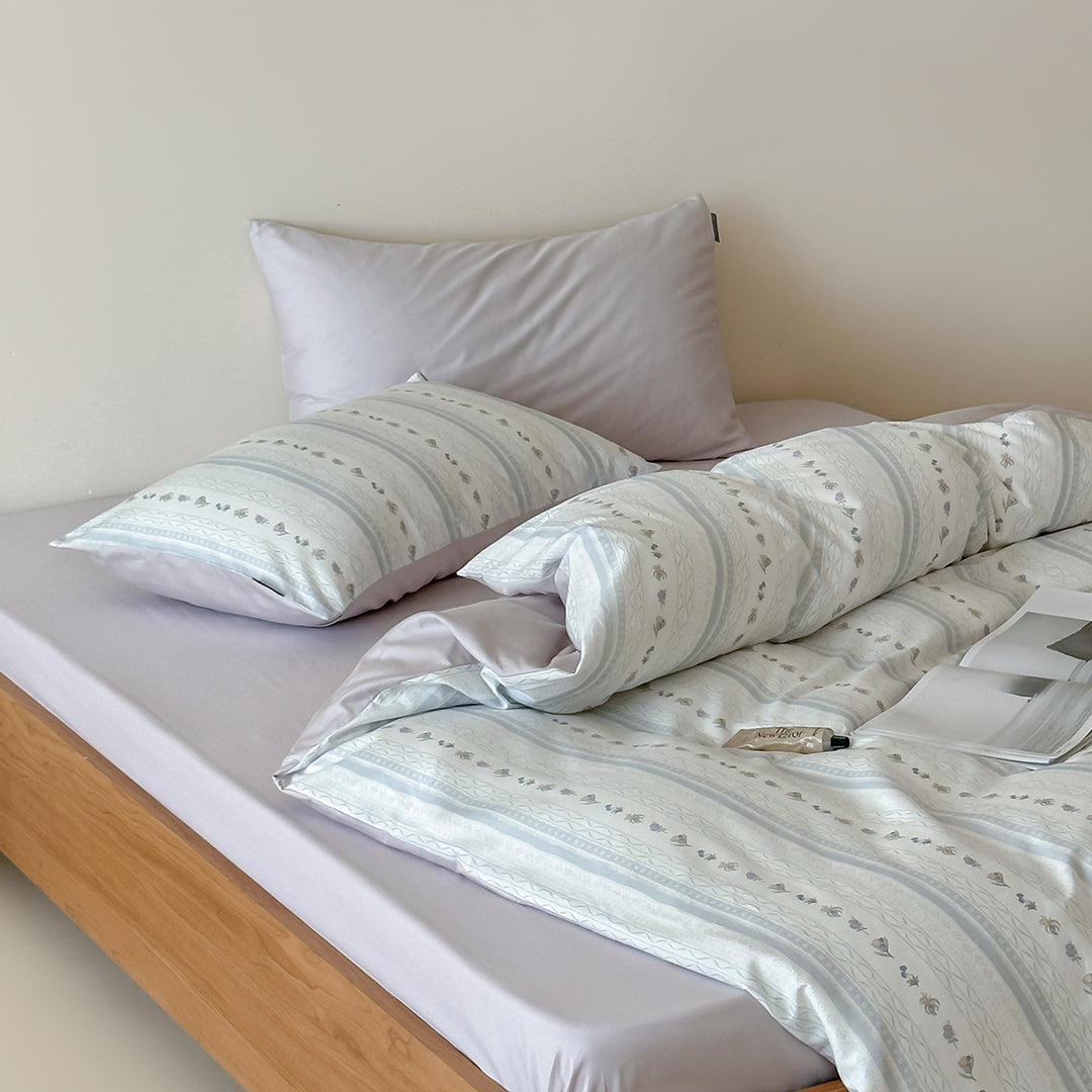 Cotton percale bed linen set with subtle floral stripe pattern and reversible material