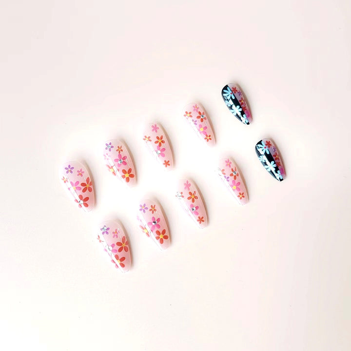 Artificial nail set with floral 3D embellishments and glitter accents Stornfield