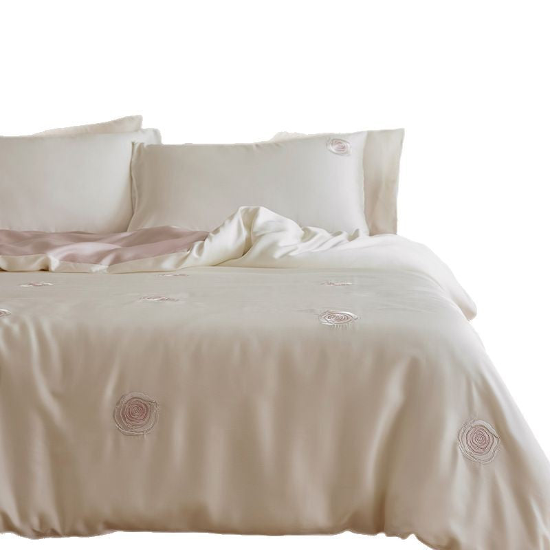 Luxurious satin bedding set with floral embroidered rose details and reversible function