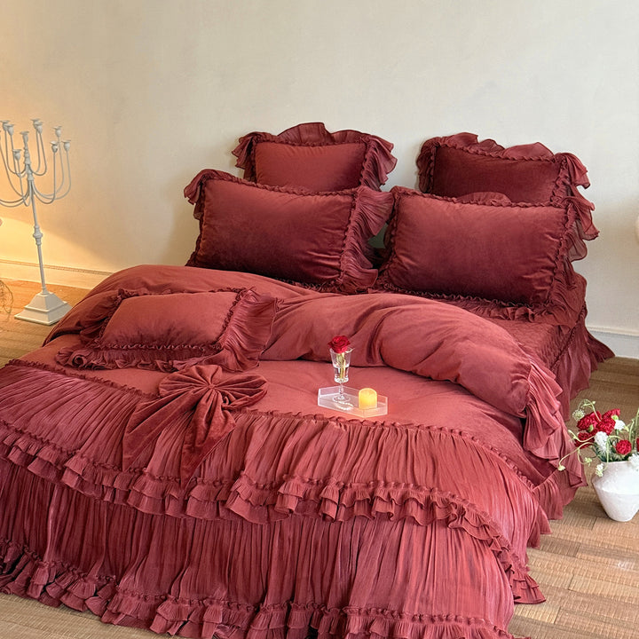 Romantic ruffled velvet bed set with pleated frills and decorative cushions