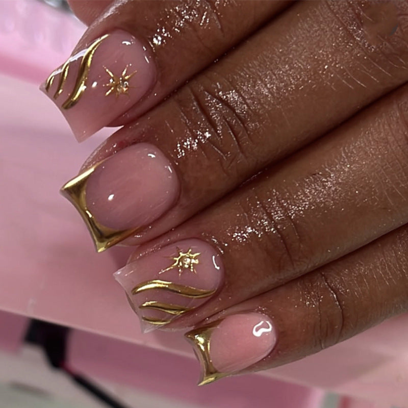Artificial nail art with glamorous golden accents Stornfield