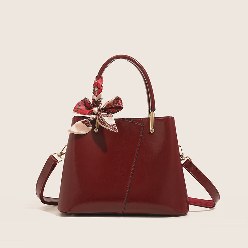 Stylish Structured Handbag with Decorative Scarf