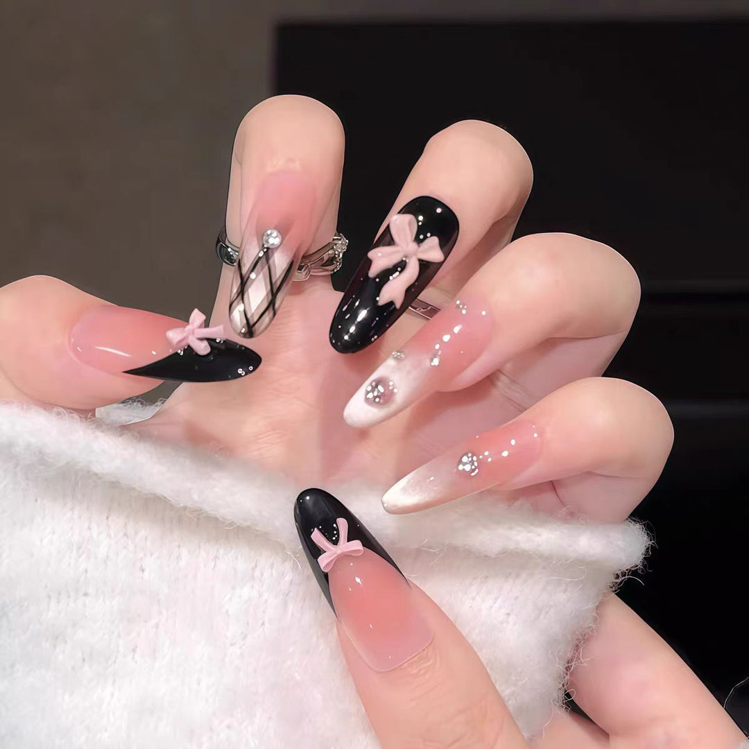 Artificial nails with playful bow design and glitter effects Stornfield