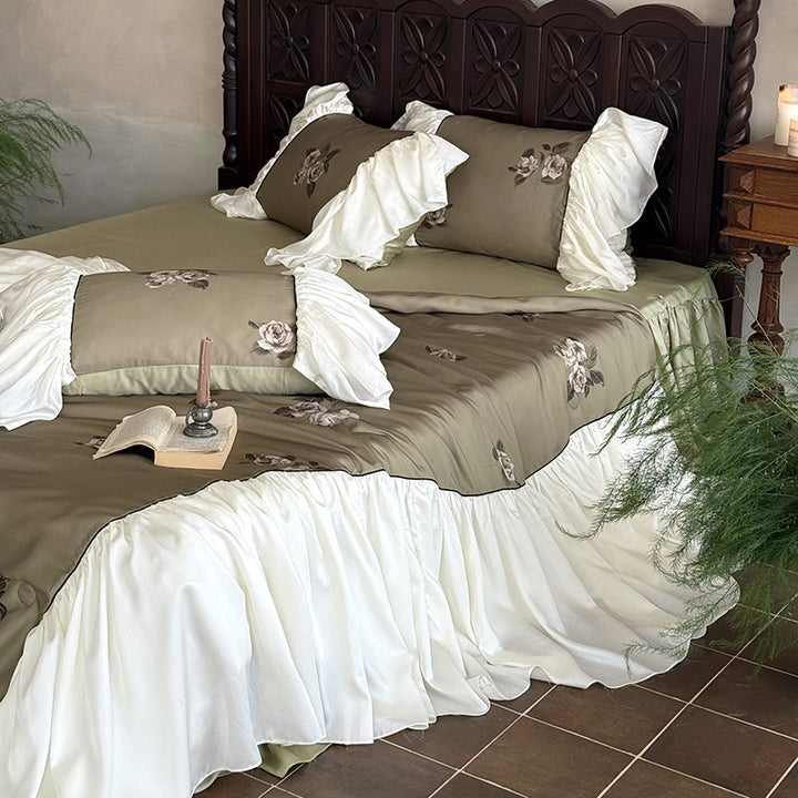 Romantic cotton satin bedding set with ruffled bed skirt and embroidered rose appliqués