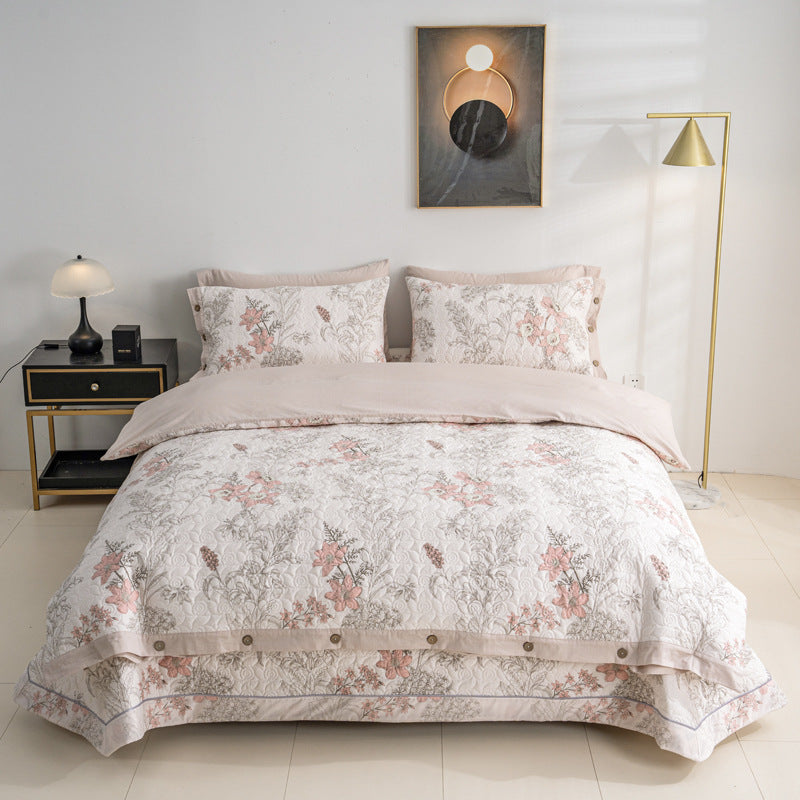 Quilted bedspread and bedding set with floral print, reversible function and decorative button placket