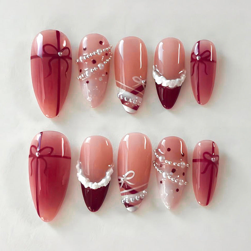 Nail set with glamorous bows and elegant pearl embellishments Stornfield