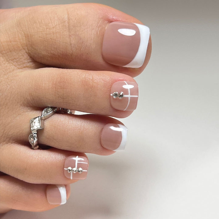 Artful toenail design with elegant style and rhinestone embellishments Stornfield