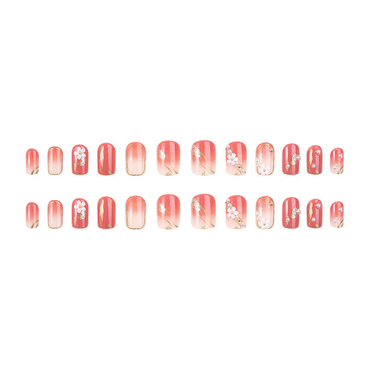 Acrylic nail set with elegant floral decorations and glamorous pearl accents Stornfield