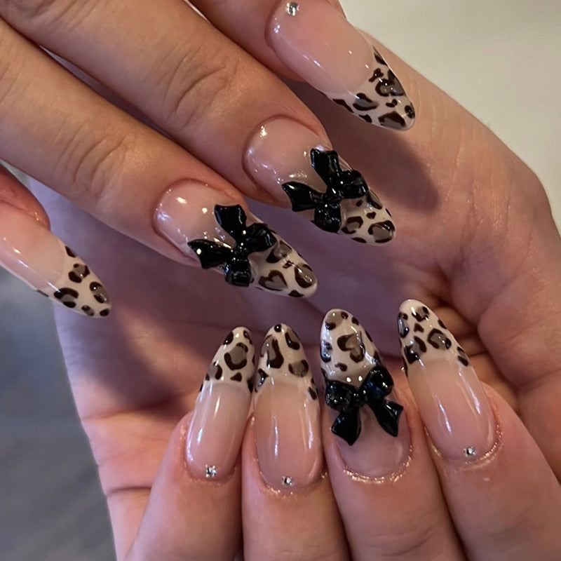 Creative artificial nails with stylish leopard pattern and bow accents Stornfield