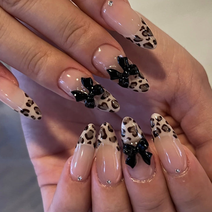Creative artificial nails with stylish leopard pattern and bow accents Stornfield