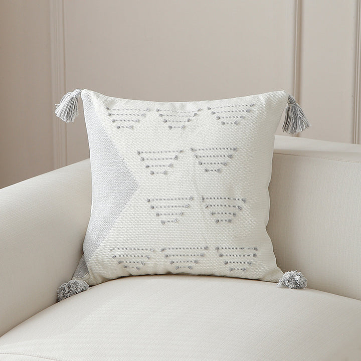 Decorative woven cushion cover with geometric tuft-relief and tassels Stornfield
