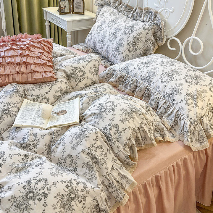 Romantic quilted comforter with ruffled border and fine floral pattern