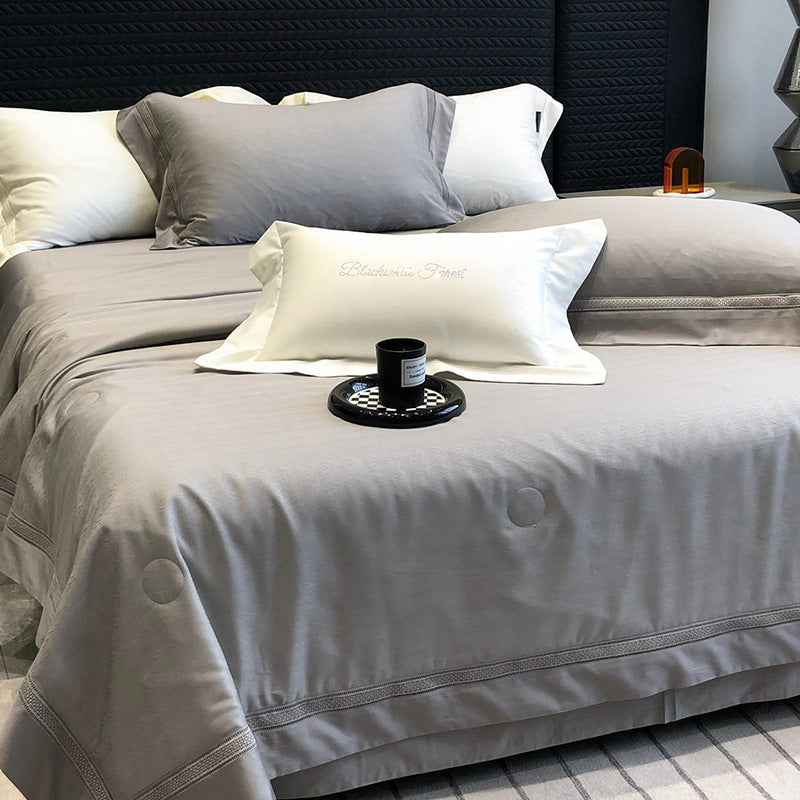 Premium bedding set made of cotton satin with subtle circle stitching and hotel closure