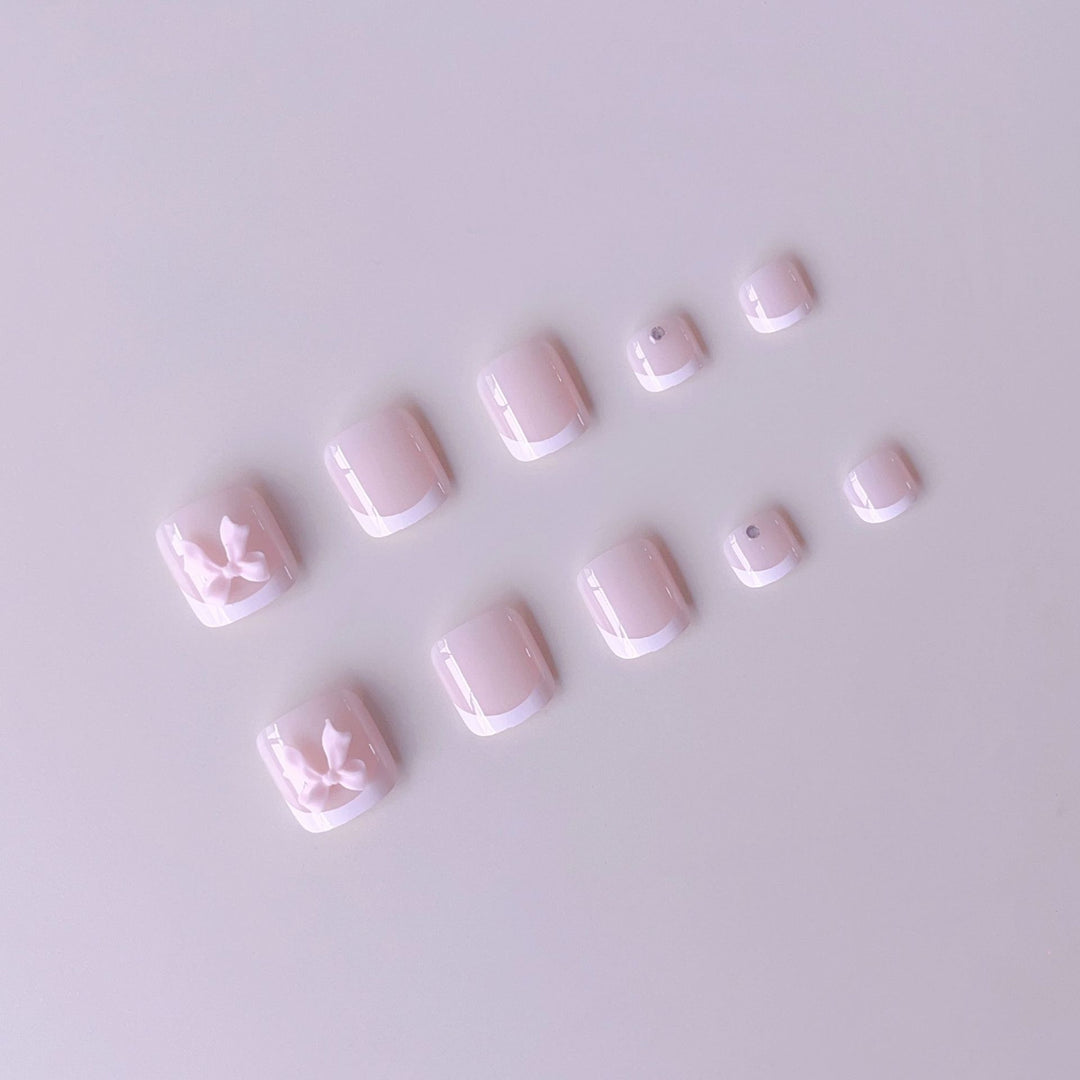 Nail art set with elegant French design and romantic bows Stornfield