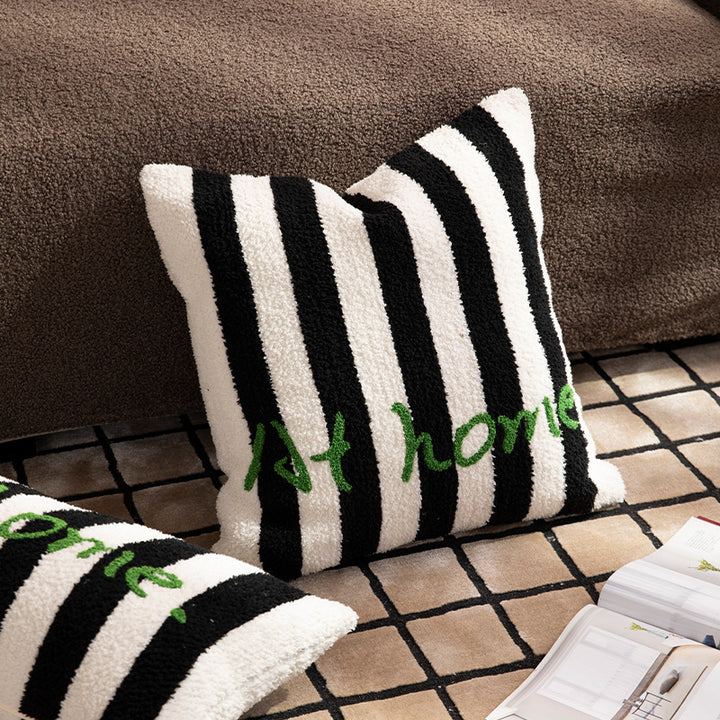 Striped bouclé decorative pillow with embroidered lettering and cuddly filling