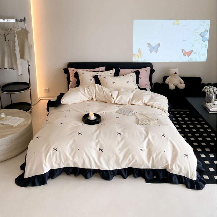 Reversible cotton satin bedding set with fine bow embroidery and ruffled edge