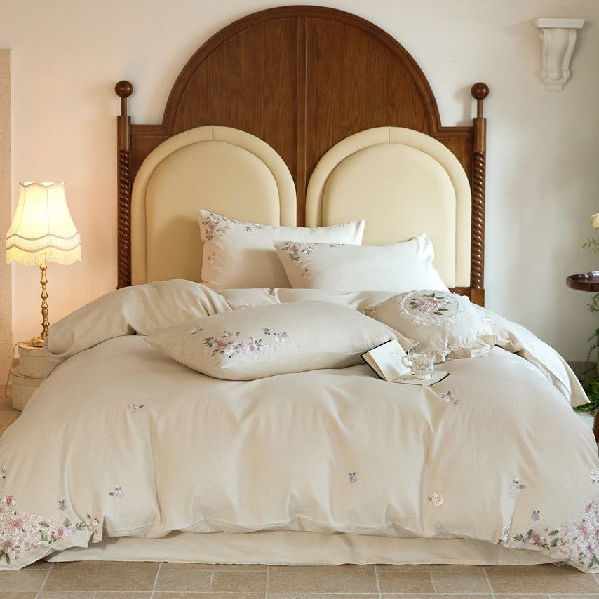Romantic cotton satin duvet cover set with delicate floral embroidery and decorative pillow