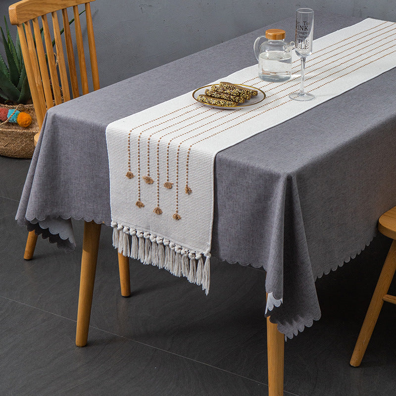 Decorative table runner in Scandinavian-minimalist design with macrame fringes Stornfield