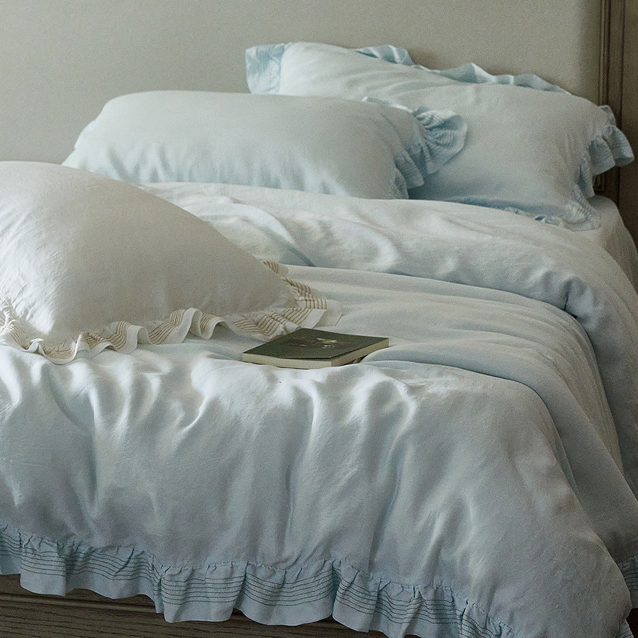 Cotton muslin duvet cover and pillowcase set with ruffle trim and finely striped piping