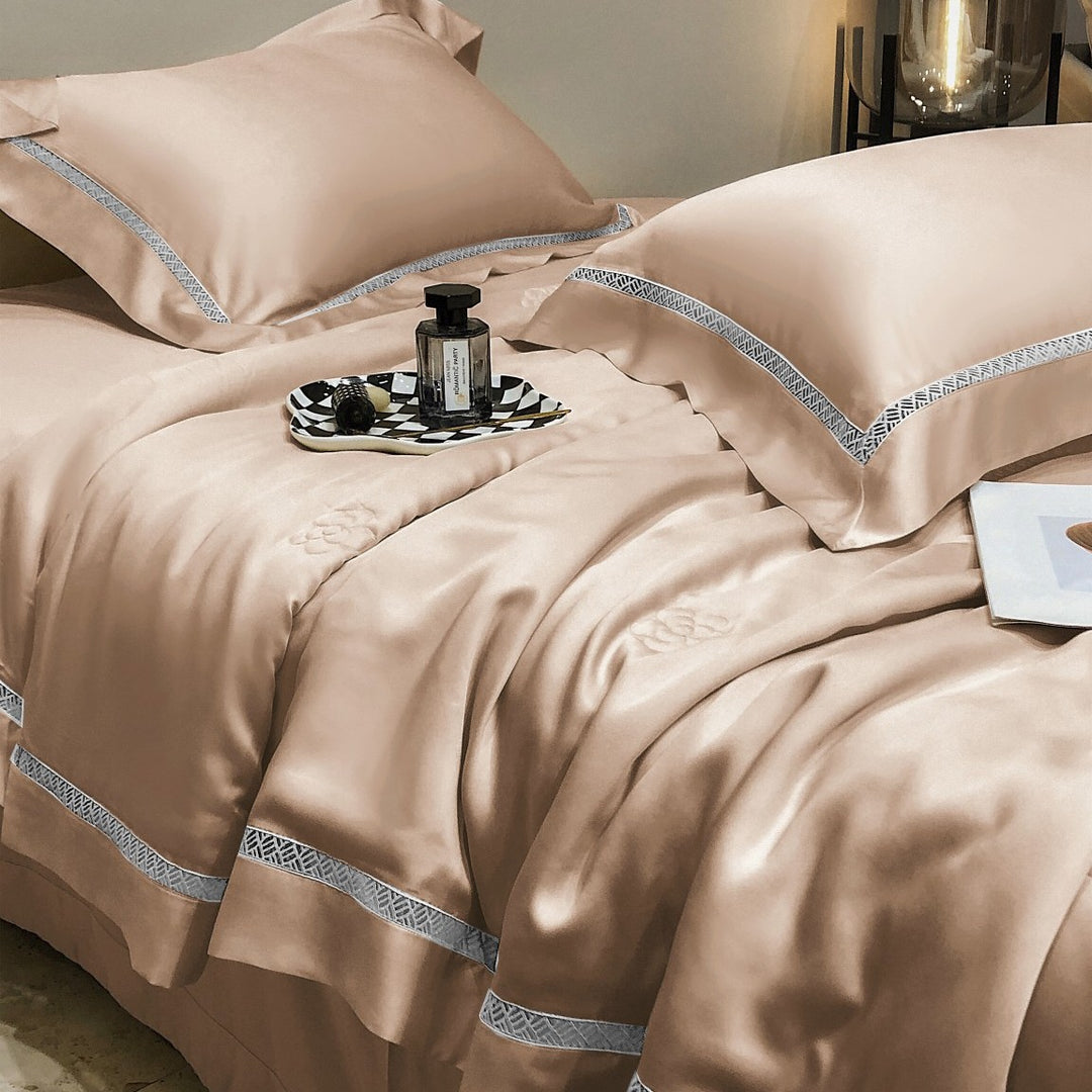 Luxurious satin bedding set with fine embroidered border and tone-on-tone floral relief
