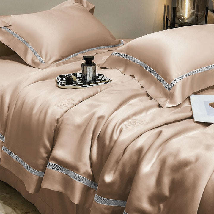 Luxurious satin bedding set with fine embroidered border and tone-on-tone floral relief