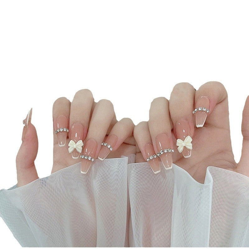 Artificial nails with elegant bow accents and pearl decorations Stornfield