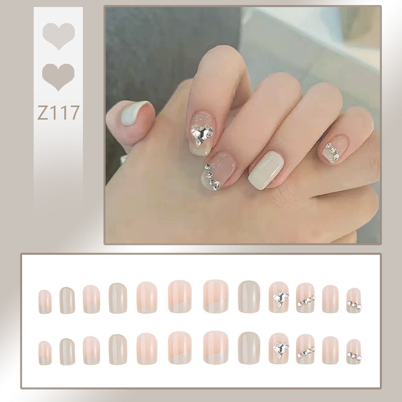 Glamorous artificial nails with heart and rhinestone decorations Stornfield