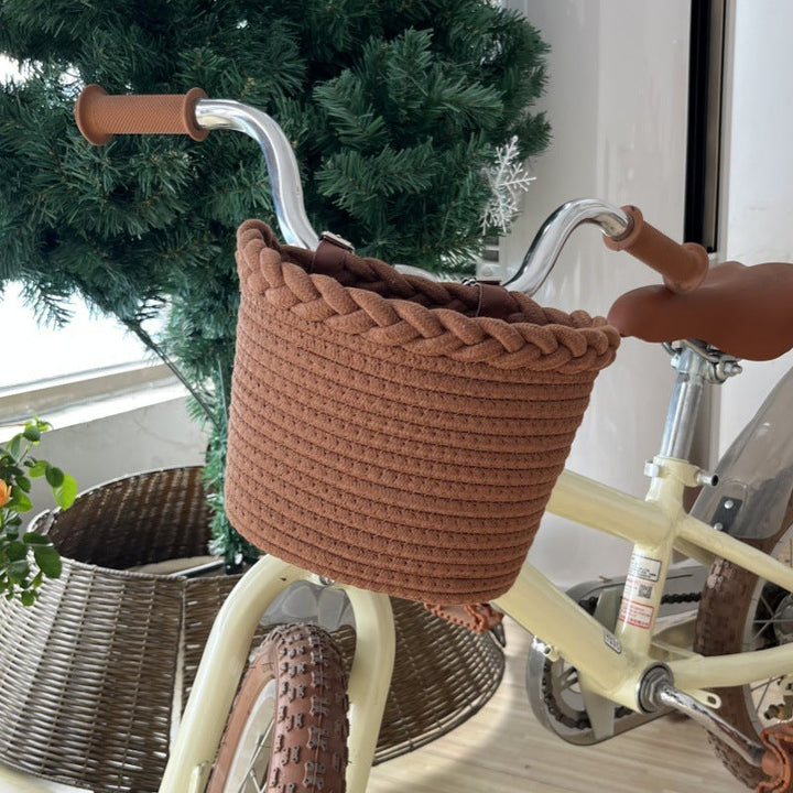 braided rope bike basket with pom pom embellishments and leather handlebar straps Stornfield
