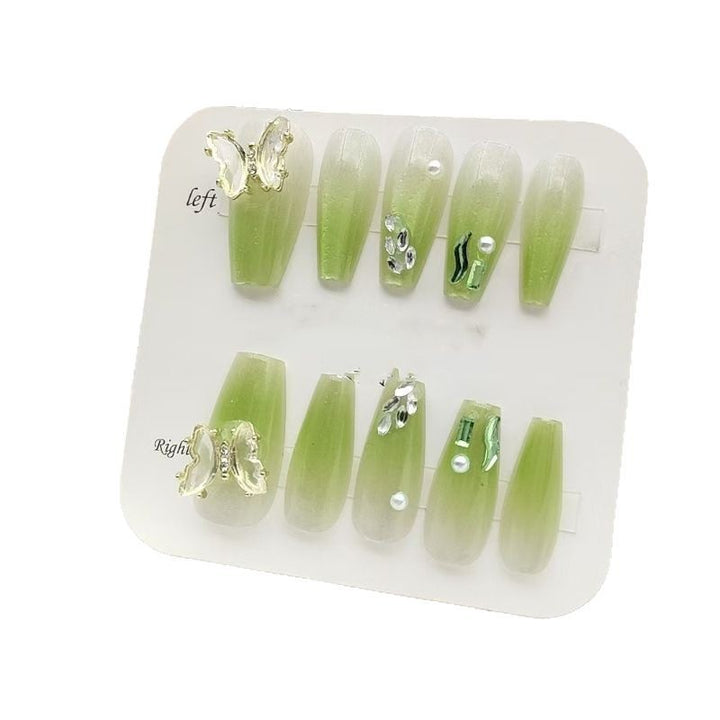 Artificial nails with butterfly accents and glitter details Stornfield