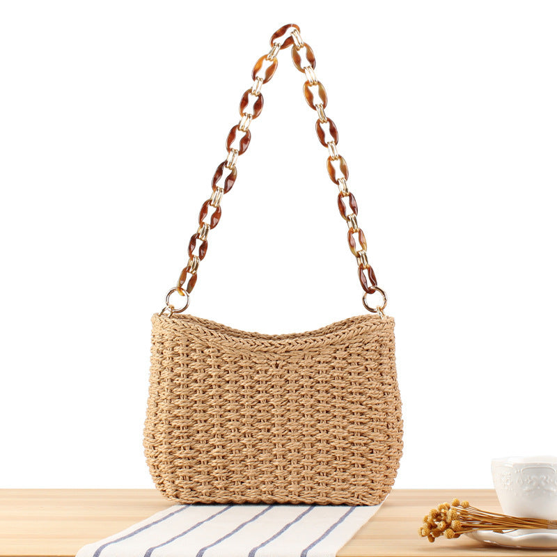 Stylish handbag made of woven natural material with exclusive chain accents Stornfield