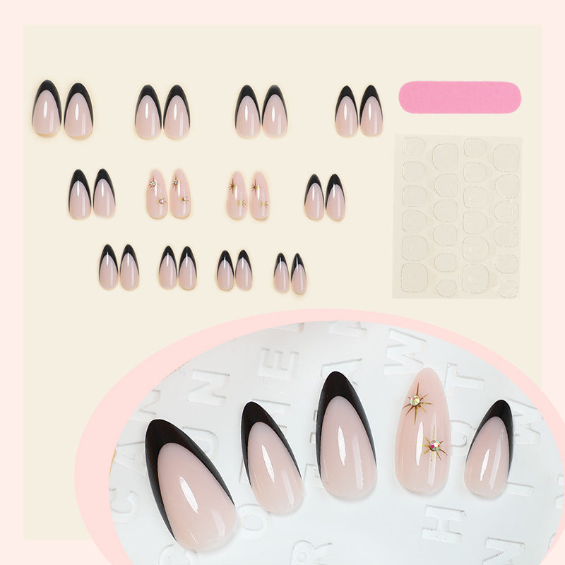 Artificial nail set with elegant black-and-white design and golden star accents Stornfield